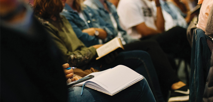 People sitting with open books in their laps