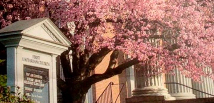 Wayside pulpit in front of First Unitarian Church with cherry tree in bloom